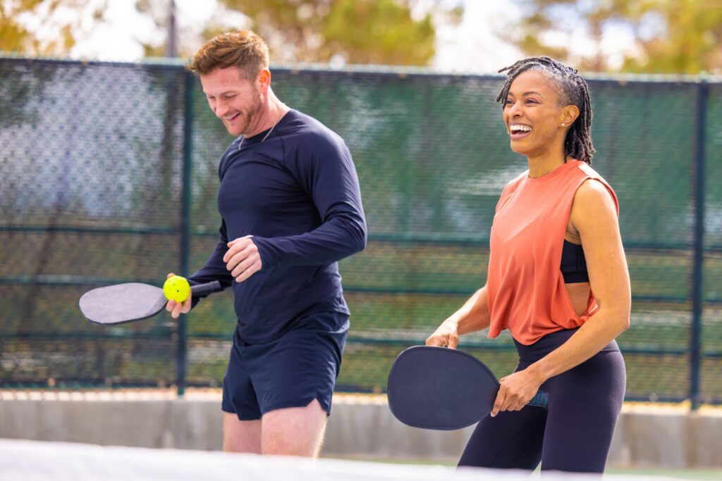 A man and a woman enjoying a game of pickleball.