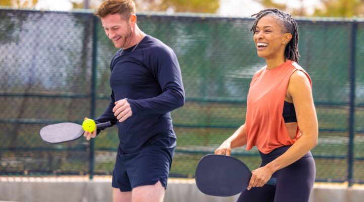 A man and a woman enjoying a game of pickleball.